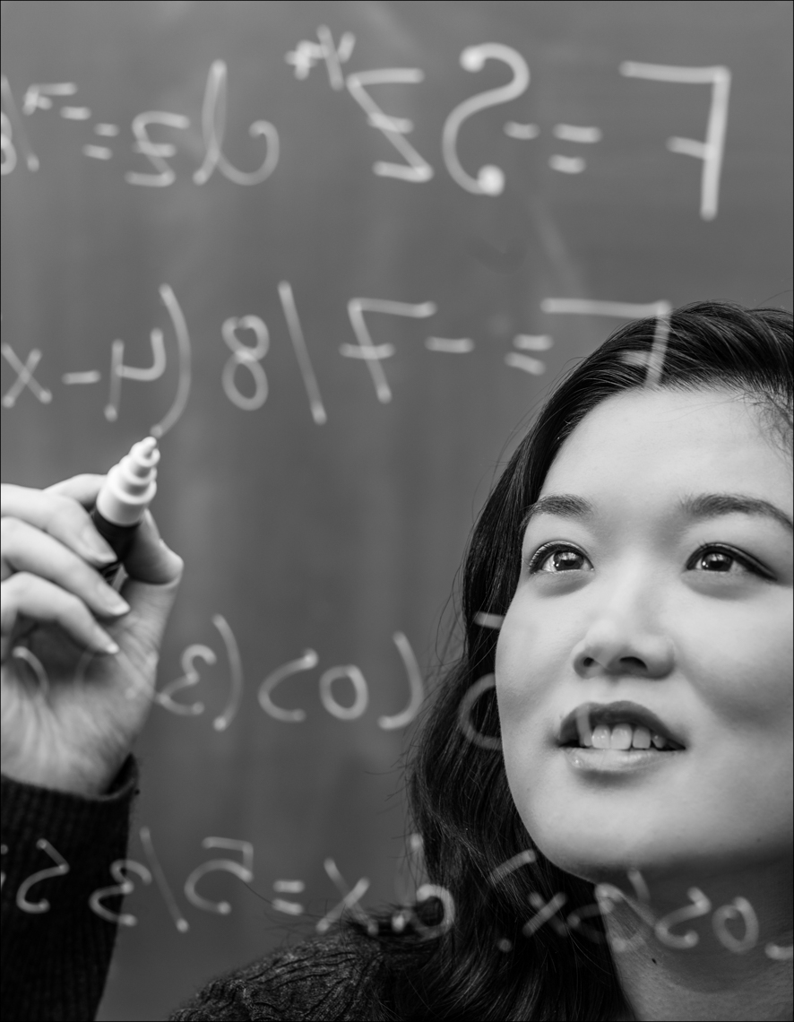 An Asian American student solving mathematical equations.