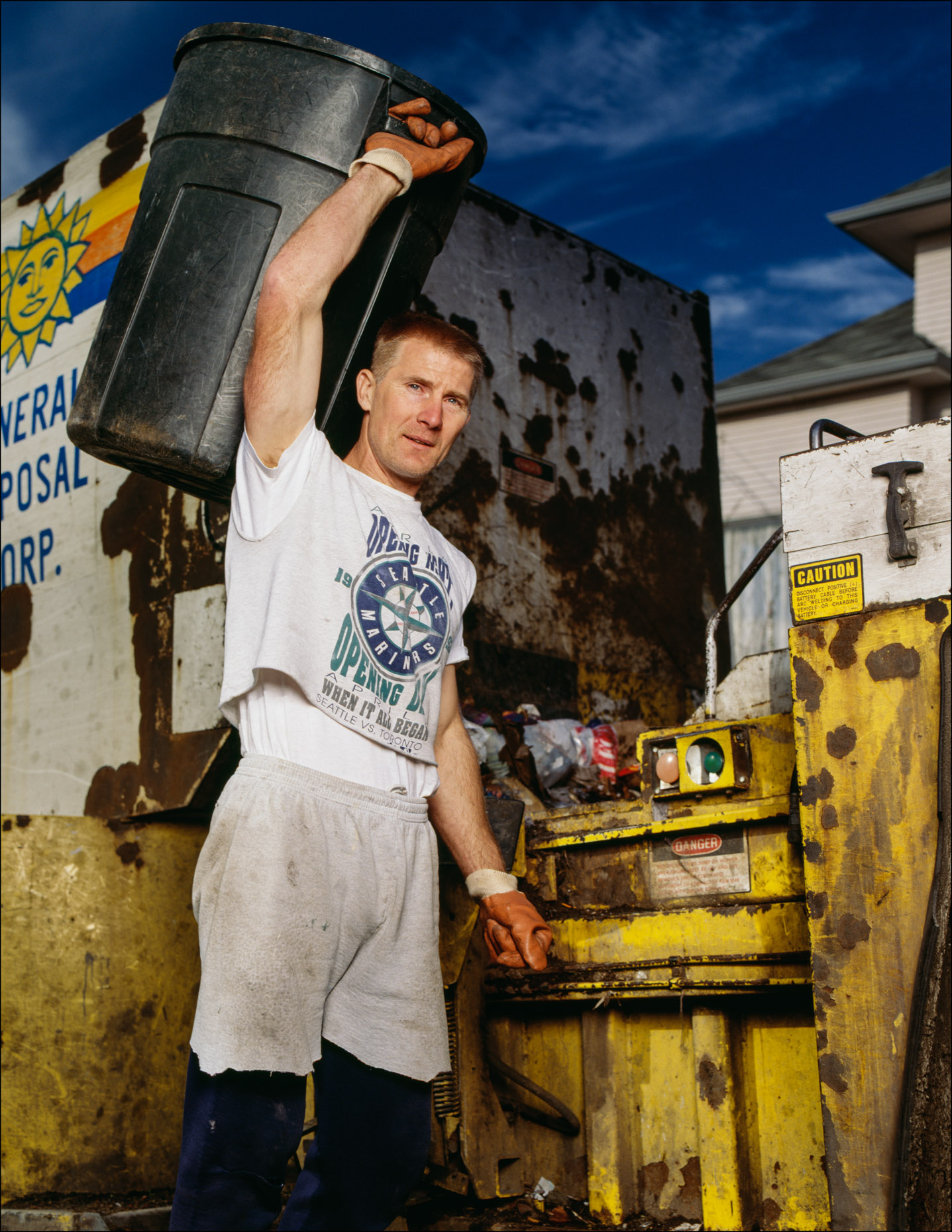 Sanitation worker/garbage man holding garbage can, portrait.